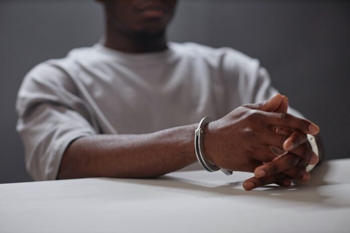 close-up-of-black-young-man-wearing-handcuffs-as-arrested-criminal.jpg